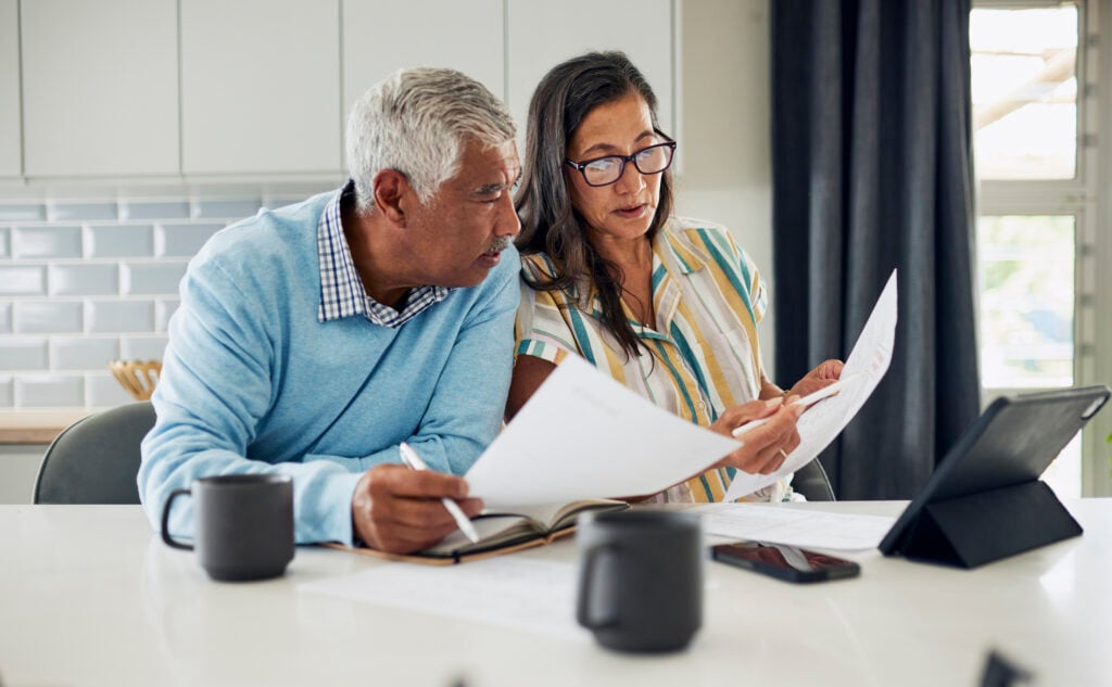 Man and woman sitting and looking at estate documents