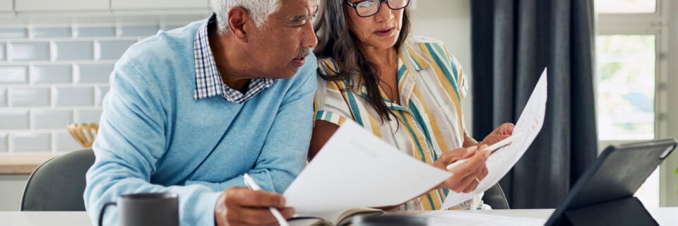 Man and woman sitting and looking at documents