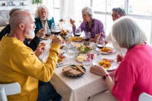 group of friends gather at table to enjoy mediterranean meal